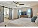 This is the main bedroom that features a large TV, lots of light, and sliding barn doors at 5065 Timberbridge Ln, Johns Creek, GA 30022