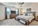 Spacious main bedroom featuring a ceiling fan, carpet flooring, TV, and two large windows with drapes at 5065 Timberbridge Ln, Johns Creek, GA 30022