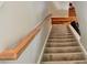 Carpeted staircase with a wooden handrail, and a view of the upper level hallway at 5065 Timberbridge Ln, Johns Creek, GA 30022