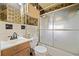 A small bathroom featuring a sliding glass shower door and patterned wallpaper at 853 Erin Sw Ave, Atlanta, GA 30310