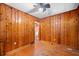 Bedroom with wood paneling, hardwood floors, a ceiling fan, and a doorway at 853 Erin Sw Ave, Atlanta, GA 30310