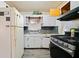 A kitchen view with a white refrigerator, gas stove, and overhead cabinets at 853 Erin Sw Ave, Atlanta, GA 30310