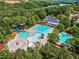 Aerial view of a community pool, lake, and clubhouse surrounded by lush trees at 330 Tupelo Trl, Canton, GA 30114