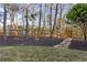 View of the mulched backyard with a charming wooden fence and a stone pathway to a gated entrance at 330 Tupelo Trl, Canton, GA 30114