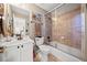 A well-lit bathroom featuring a single vanity and shower-tub combination at 330 Tupelo Trl, Canton, GA 30114