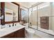 Bathroom with shower-tub combination, framed art, and bronze fixtures at 330 Tupelo Trl, Canton, GA 30114