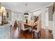 Elegant dining room featuring hardwood floors, wainscoting, and a bay window with plantation shutters at 330 Tupelo Trl, Canton, GA 30114