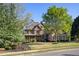 Elegant two-story stone-and-brick home with professionally landscaped front yard and mature trees at 330 Tupelo Trl, Canton, GA 30114