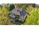 Back exterior view of beautiful home with a screened porch and lush landscaping at 330 Tupelo Trl, Canton, GA 30114