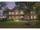 Beautiful two-story home with a stone and brick facade, a covered porch and meticulously manicured lawn at 330 Tupelo Trl, Canton, GA 30114