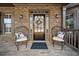 Charming front porch featuring decorative chairs and a welcoming front door with a floral wreath at 330 Tupelo Trl, Canton, GA 30114