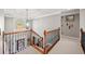 Upstairs hallway featuring wrought iron and wood railing and neutral paint at 330 Tupelo Trl, Canton, GA 30114