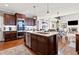 Spacious kitchen featuring dark wood cabinetry, stainless steel appliances, and a central island at 330 Tupelo Trl, Canton, GA 30114