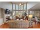 Living room featuring a fireplace, soaring windows, and beautiful hardwood floors at 330 Tupelo Trl, Canton, GA 30114