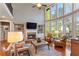 Living room featuring a fireplace, soaring windows, and built in bookshelves at 330 Tupelo Trl, Canton, GA 30114