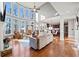 Bright living room featuring a wall of windows, a fireplace, and hardwood floors at 330 Tupelo Trl, Canton, GA 30114