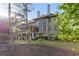 Back exterior featuring screened porch, mature trees and lush lawn at 330 Tupelo Trl, Canton, GA 30114