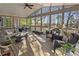 Inviting screened porch features multiple seating areas and vaulted ceilings at 330 Tupelo Trl, Canton, GA 30114