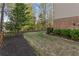 A well-kept yard featuring a lush lawn, mulched garden beds, and a charming wooden fence at 330 Tupelo Trl, Canton, GA 30114