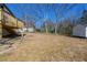 Home boasts backyard with a wooden deck offering space for outdoor activities and storage shed at 8176 Camp St, Douglasville, GA 30134