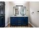 Bathroom featuring a modern double vanity with stylish gold hardware and mirrors at 8176 Camp St, Douglasville, GA 30134