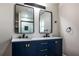 Bathroom featuring a double vanity with stylish gold hardware and modern mirrors at 8176 Camp St, Douglasville, GA 30134