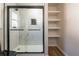 Modern bathroom boasts glass enclosed shower with shelving at 8176 Camp St, Douglasville, GA 30134