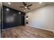 Open bedroom with luxury vinyl plank flooring and a dark accent wall at 8176 Camp St, Douglasville, GA 30134