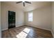 Bedroom with a ceiling fan, wood-look flooring and a window at 8176 Camp St, Douglasville, GA 30134