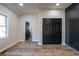 Bedroom showcasing wood floors, natural light, and dark closet doors at 8176 Camp St, Douglasville, GA 30134