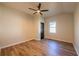 Bright bedroom features modern ceiling fan, hardwood floors, and natural light from a window at 8176 Camp St, Douglasville, GA 30134