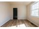 Bedroom features wood-look flooring, window and neutral paint at 8176 Camp St, Douglasville, GA 30134
