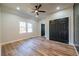 Bright bedroom featuring wood floors, a ceiling fan, and a large window at 8176 Camp St, Douglasville, GA 30134