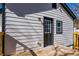 View of the back of the house with new siding and a wooden deck at 8176 Camp St, Douglasville, GA 30134