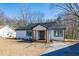 Newly renovated home with fresh exterior paint, and a inviting porch at 8176 Camp St, Douglasville, GA 30134