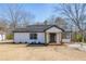 Charming renovated home showcasing a freshly painted exterior, inviting front porch and manicured lawn at 8176 Camp St, Douglasville, GA 30134