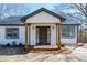 Welcoming facade displaying a freshly painted exterior, a cozy front porch, and a neatly kept lawn at 8176 Camp St, Douglasville, GA 30134