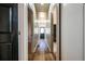 Long hallway with hardwood floors and a black front door creates a welcoming entrance at 8176 Camp St, Douglasville, GA 30134