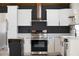 Spacious kitchen featuring white cabinets, stainless steel appliances, and mobile island at 8176 Camp St, Douglasville, GA 30134