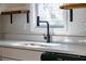 Close-up of kitchen sink with quartz countertops and black faucet at 8176 Camp St, Douglasville, GA 30134