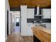 Modern kitchen with stainless steel appliances, white cabinets, and a stylish wooden countertop at 8176 Camp St, Douglasville, GA 30134