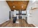 Bright kitchen boasts white cabinets, stainless steel appliances, and a striking wood plank ceiling at 8176 Camp St, Douglasville, GA 30134
