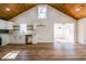 Open concept with kitchen, white cabinets, wood plank ceiling, and hardwood style floors at 8176 Camp St, Douglasville, GA 30134