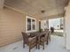 Covered patio featuring an outdoor dining set with seating for six and tan siding at 1227 Clear Stream Rdg, Auburn, GA 30011