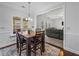 Cozy dining area with a wooden table, upholstered chairs, and natural light filtering through the windows at 1227 Clear Stream Rdg, Auburn, GA 30011