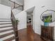 Bright foyer featuring hardwood floors, staircase with iron railing, and a decorative console table at 1227 Clear Stream Rdg, Auburn, GA 30011