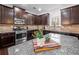 Modern kitchen with stainless steel appliances and dark wood cabinets at 1227 Clear Stream Rdg, Auburn, GA 30011