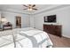 Neutral primary bedroom with tray ceilings and ceiling fan, a large window, and light-colored carpet at 1227 Clear Stream Rdg, Auburn, GA 30011