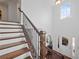 Elegant staircase with wood treads, wrought iron spindles, and natural light from window in entryway at 1227 Clear Stream Rdg, Auburn, GA 30011