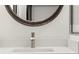 Close-up of a modern bathroom sink with an oval mirror and a silver faucet at 2327 Mason Dr # D23, Atlanta, GA 30316